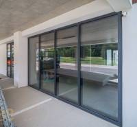 Glazed commercial spaces in Svit with parking and modern architecture.
