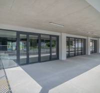 Commercial premises in the town of Svit with a glass entrance and a concrete ceiling.