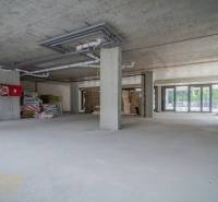 Commercial premises under renovation with glass and concrete, ready for modifications.