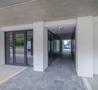 Commercial premises in Svit with glass doors and tiled floor next to a parking lot.