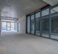 Spacious commercial spaces with large glass walls and views outside.
