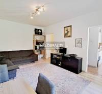 Living room in a 3-room apartment with a sofa, carpet, and built-in wardrobe.