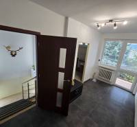 Interior of a family house with a hallway, staircase, and a spacious view of the garden.