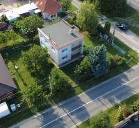 A family house in Rakoľuby in Nové Mesto nad Váhom surrounded by greenery and a street.