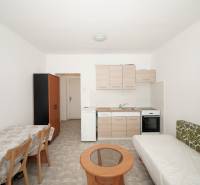 Offices with a kitchenette, dining table, sofa, and wardrobe.