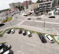 Roundabout on Hlavná Street in Dunajská Streda, surrounded by apartment buildings and a parking lot.