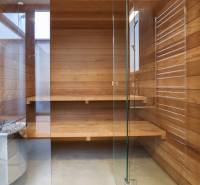 Wooden sauna with glass doors and benches in a family house.