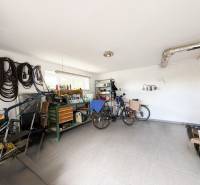 A garage of a family house with bicycles and tools.
