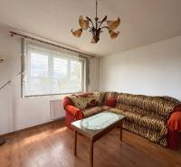 Living room with a sofa, table, and floor lamp in a family house.