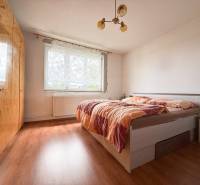 Bedroom in a family house with a double bed and a large wardrobe.