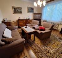 Living room in a family house with comfortable furniture and an oriental rug.
