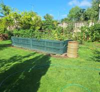 A garden at a family house on Šalská Street in Šaľa with a raised bed and lawn.