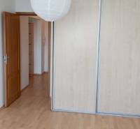 A room in a 3-room apartment with wooden floors and a wardrobe with sliding doors.