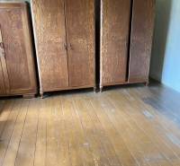 Wooden cabinets on a wooden floor in a room of a family house.