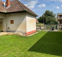 A family house in Trenčianske Stankovce with a grassy plot and a brick roof.