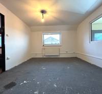 An empty room in a 4-room apartment with a window, light, and a heating unit.