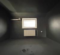 A dark room in a 4-room apartment with air conditioning and a radiator under the window.