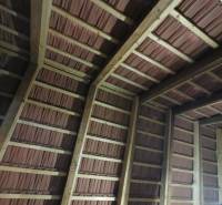 Roof structure with a wooden frame and brick covering in a family house.