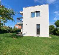 A family house in Vojka nad Dunajom with a white facade and a lawn in the garden.
