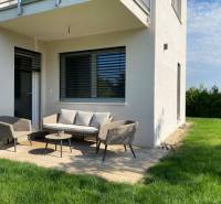 A family house in Vojka nad Dunajom with a terrace, garden furniture, and a lawn.