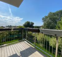 The balcony of a family house in Vojka nad Dunajom with a view of the green garden.