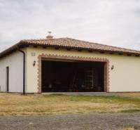 A family house in Krupina on Kopanice Street with an open garage and a tiled roof.