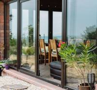 Glass doors and flowers in the garden of a family house in Kopanice, Krupina.