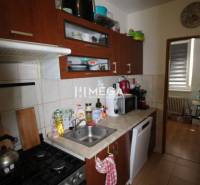 A kitchen in a 2-room apartment with appliances and storage space.