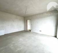 An empty interior in a family house with a large window, white ceiling, and walls.