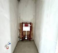 An unfinished room in a family house with outlets for a sink or toilet.