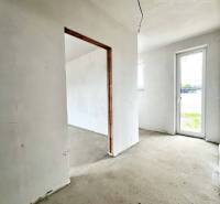 The interior of a family house in the renovation stage with light walls and doors to the terrace.