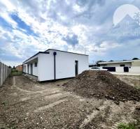 A family house in Miloslavov with land and a building, the sky is cloudy.