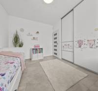 Children's room in a family house with a bed, bookshelf, and wardrobe with a children's motif.