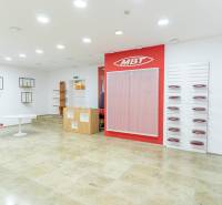 Spacious offices with white walls, shelves, and red accessories on Michalská in Bratislava.
