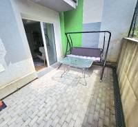 A terrace with a swing and a table in Bánovce nad Bebravou at a 1-room apartment.