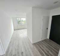 A bright hallway and floor in a 3-room apartment with a large window.