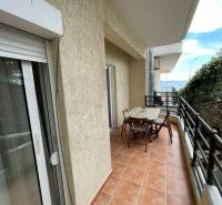 A balcony with seating in a holiday apartment in Sarandë, with a sea view.