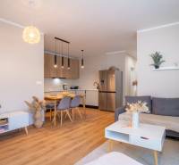 Interior of a family house with a kitchen, dining table, and living area.
