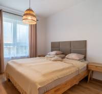 Bedroom in a family house with a wooden bed and a nightstand.