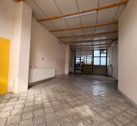 Interior of commercial premises with tiling and a window, suitable for rent.