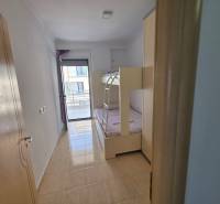 Children's room in a holiday apartment with access to a balcony and a bunk bed.