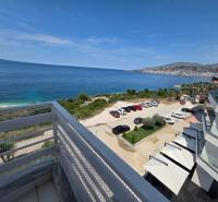 View from a holiday apartment in Sarandë of the sea and the parking lot near the building.