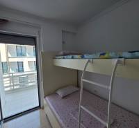 Bunk bed in the bedroom of the Holiday Apartment, with a view of the balcony.