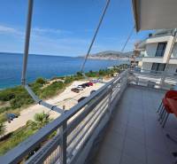 The balcony of a holiday apartment in Sarandë with a view of the blue sea and coastline.