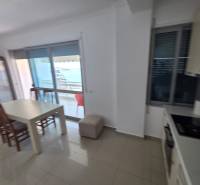 Dining area with a sea view in a vacation apartment, bright interior design.