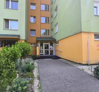 Entrance to the apartment building on Osuského Street in Bratislava - Petržalka with landscaped greenery.