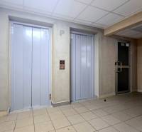 A hallway with two elevators and a door in a 3-room apartment on Osuského Street.