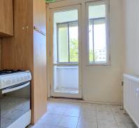 A kitchen in a 3-room apartment with a gas stove and access to a loggia.