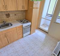 A kitchen in a 3-room apartment with a sink, gas stove, and loggia.
