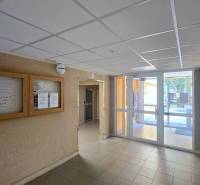 The entrance hall of the apartment building with information boards, secured by a security camera system.